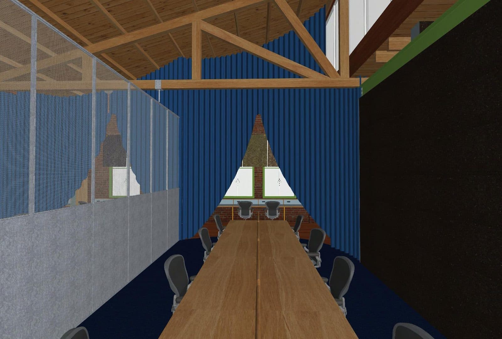 A shared room of dedicated desks at MASS under the trusses